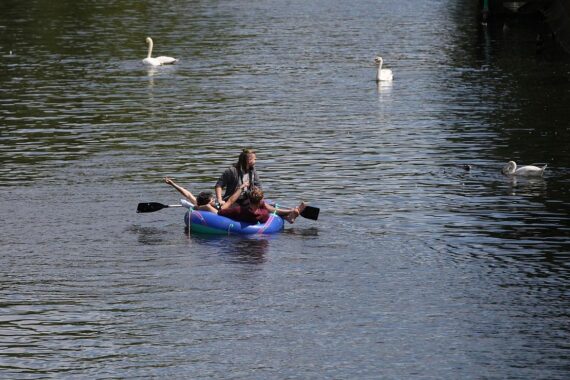 Junge Menschen in einem Schlauchboot am Rhein, Symbol für bevorstehendes Badeverbot in Köln.