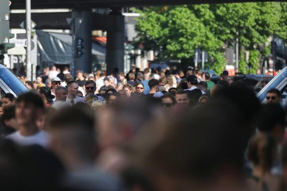 Menschen diskutieren besorgt auf der Straße über die Russland-Politik und NATO-Sicherheit.