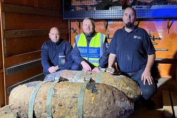 Drei Männer in Sicherheitskleidung beim Entschärfen von Weltkriegsbomben in Köln-Gremberghoven.