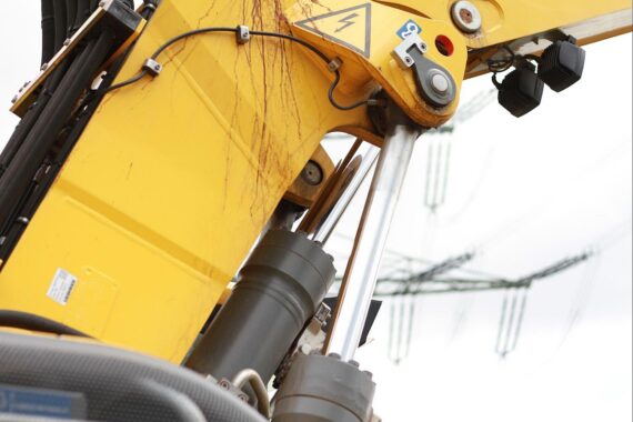 Baumaschine im Einsatz, symbolisiert Bau von energieeffizienten EH55-Effizienzhäusern.