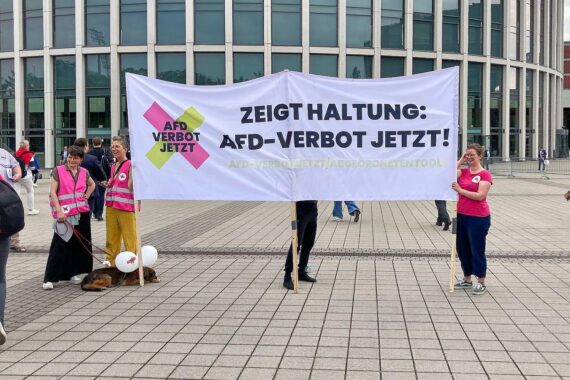 Protestierende halten Plakate gegen die Aufnahme eines Verfahrens zur Verbotsprüfung der AfD.