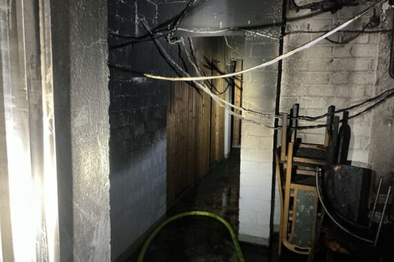 Feuerwehr im Einsatz bei Kellerbrand in Bochum, evakuierte Personen auf Balkonen.