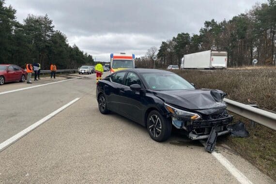 Schwarzer Nissan nach schwerem Unfall auf Autobahn, vermutetes illegales Straßenrennen, Polizei ermittelt.