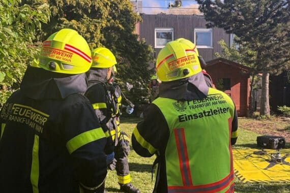 Großer Feuerwehreinsatz in Frankfurt-Nied wegen Dachstuhlbrand, viele Einsatzkräfte vor Ort sichtbar.