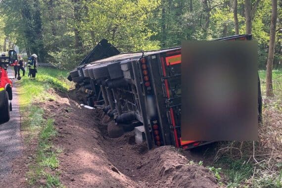 Verkehrsunfall: Lastwagen kippt mit Düngemittelbeladung, Straße gesperrt, Feuerwehr im Einsatz.