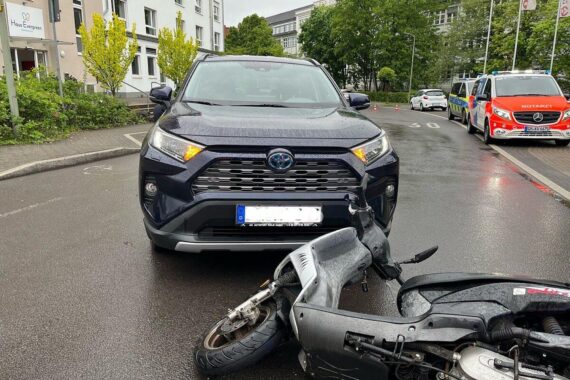 Mopedfahrer und Toyota nach Unfall; Polizei ermittelt zu schweren Verletzungen. Krankenhausfahrt erforderlich.
