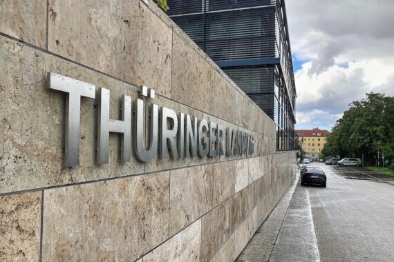 Thüringer Landtag mit Versammlung, Zeichen für demokratische Werte und Gesellschaftsverbindung.