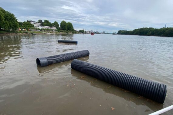 Kunststoffrohre treiben im Rhein nach Starkregen – potenzielle Gefahr für Schifffahrt.