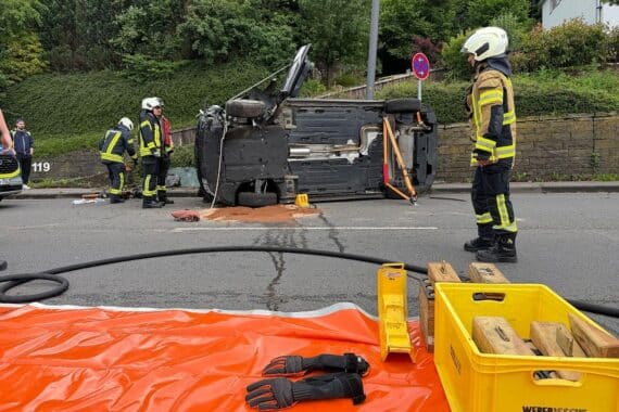 Schwerer Verkehrsunfall: PKW gegen Straßenlaterne, Feuerwehr rettet Fahrer aus umgekipptem Fahrzeug.