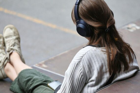 Frau mit Kopfhörern vor Berlin; SPD begrüßt Münchner KI-Musik-Urteil zur Gema und Urheberrechten.
