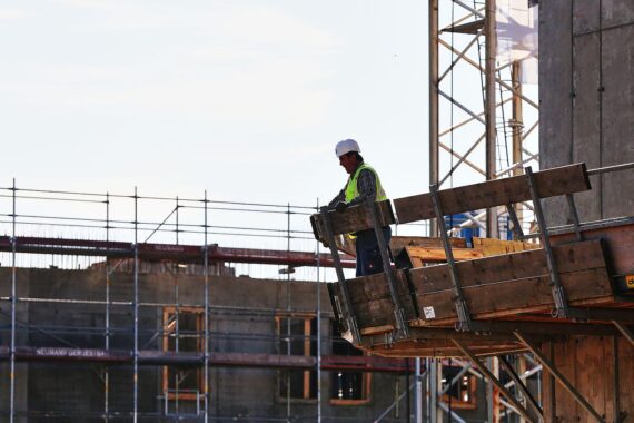 Bauarbeiter auf Baustelle: Check24 stellt Baufinanzierungsvermittlung ein, 150 Mitarbeiter betroffen.
