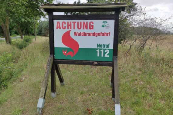 Waldbrandgefahr-Hinweisschild im Archiv, Bezug auf Klimaanpassung und bessere Waldbrandbekämpfung.