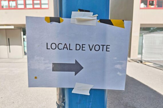 Wahllokal in der Schweiz: Stimmzettel und Wahlurne zur Volksabstimmung über Neutralität.
